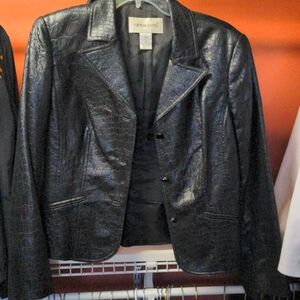 Jacket looks like leather. No working pockets. Lined
